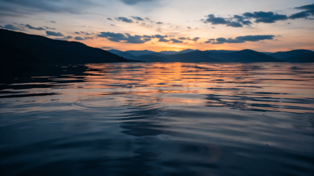 Soft ripples on calm water at dusk representing sleep hypnosis for insomnia and relaxation before restorative sleep