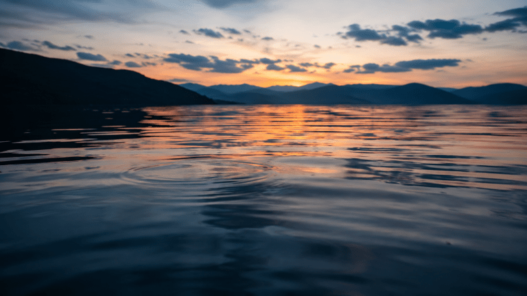 Soft ripples on calm water at dusk representing sleep hypnosis for insomnia and relaxation before restorative sleep