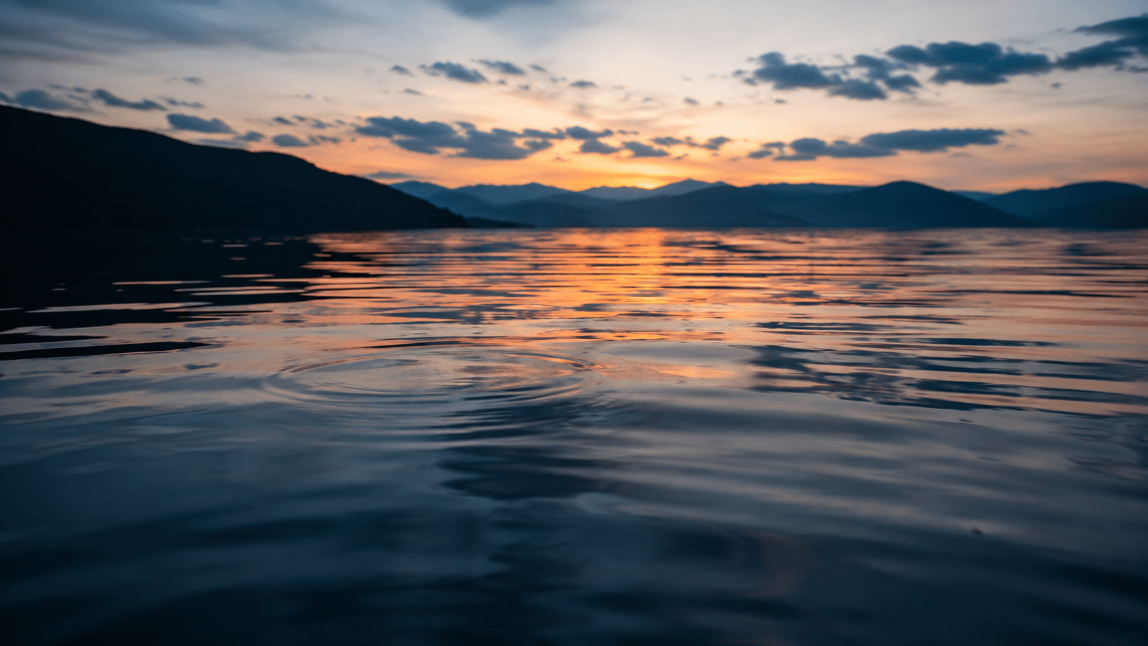 Soft ripples on calm water at dusk representing sleep hypnosis for insomnia and relaxation before restorative sleep